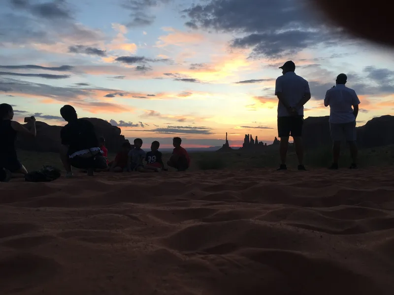 Sunrise light over Monument Valley buttes during a Navajo-guided sunrise jeep tour, Arizona/Utah